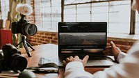 Blogger filming himself while using a laptop