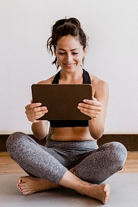Yoga instructor using a digital tablet