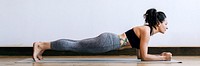 Sporty woman doing yoga in the room