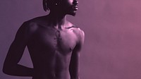 Black naked man standing by a purple background