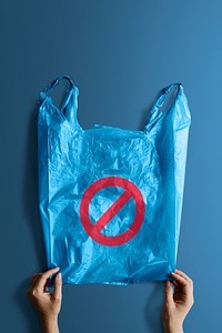 Woman holding a blue plastic bag with a ban sign