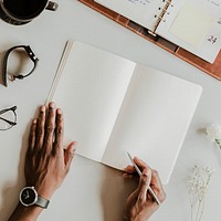 Black man writing on a notebook