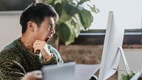 Sleepy businessman yawning in the office