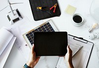 Eco-friendly engineer holding a tablet