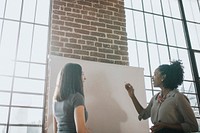 Two women discussing in a meeting