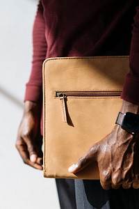 Man with a wristwatch holding a brown briefcase social template