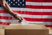 American casting his vote to a ballot box