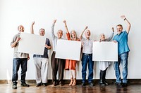 Elderly people holding blank posters