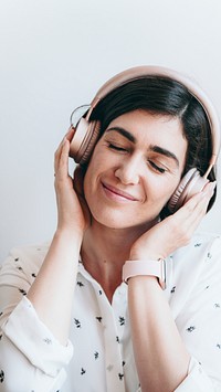 Happy woman with headphones on the couch