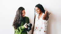 Happy women with a digital camera talking social template