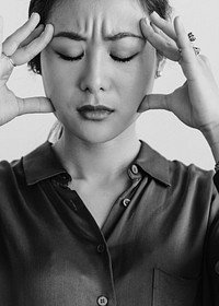Stressed woman holding her forehead