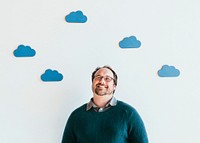 Man looking up to blue cloud icons