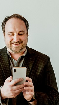 Cheerful man using his phone