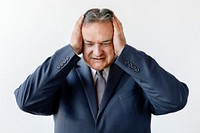 Stressed aged businessman touching his head