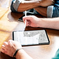 Businesspeople planning a project on digital tablet