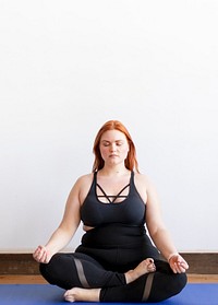 Curvy yogi woman in Padmasana pose
