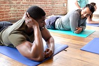 Sportive men relaxing on yoga mats
