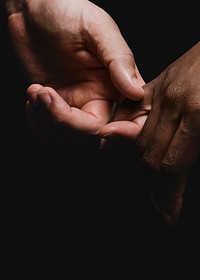 Two diverse people holding hands photo closeup