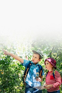 Two cute kids trekking in the forest text space 