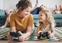 Sisters lying on the floor playing a video game
