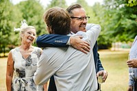 Fathers of the bride and groom hugging it out