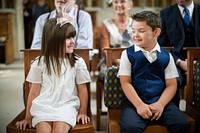 Two little kids at a wedding ceremony
