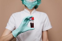 Nurse holding blood test tubes 