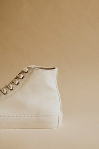 White high top sneakers on beige