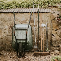 Gardening tools leaning on a shed