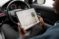 Man using digital tablet in car photo