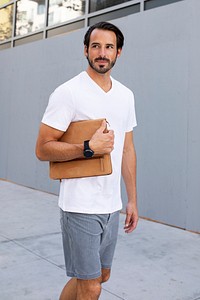 Man holding clutch walking in the city