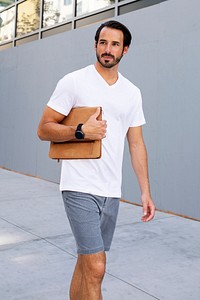 Man holding clutch walking in the city