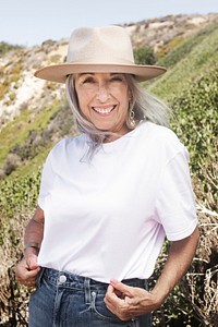 Mature woman in white tee and panama hat for summer outdoor shoot