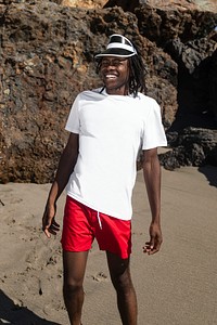 Man in sun visor hat and white tee outdoor photoshoot