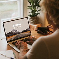 Woman using laptop, working from home photo