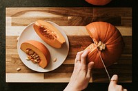 Woman slicing pumpkin for Thanksgiving dinner flatlay food photography