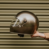 Tattoo hand holding a black helmet