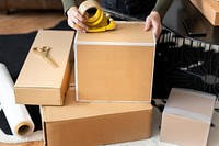 Small business owner packing product parcel boxes for delivery