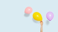 Hand holding a yellow balloon wallpaper