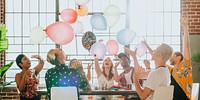 People playing with balloons at a party social banner