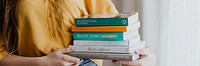 Cheerful blond girl carrying books