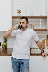 Man drinking coffee in the kitchen