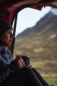 Woman in a camper with a cup of coffee
