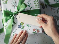 Gift box wrapped with floral patterned paper with a card