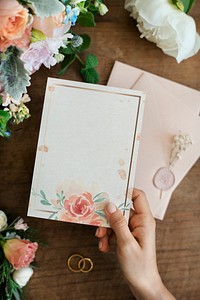 Woman holding a floral card
