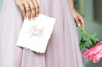 Bride holding a thank you card