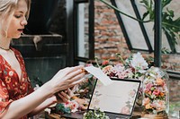 Florist using a laptop screen at work
