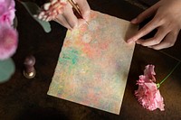 Woman writing a letter on a painted paper