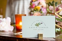 Card by bouquet of flowers on a wooden table