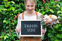 Florist holding a thank you board sign
